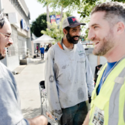 Veterans John Follmer, right, and Alejandro Rocha, left, do outreach on on Hollywood Boulevard in Los Angeles. They met Chris Brown, center, and offered to connect him with veterans services.